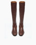 A pair of tall, brown leather boots with a smooth texture, rounded toes, and a sleek, minimalist design. 4