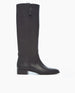 The image shows a single, tall, black leather boot with a side zipper and a low block heel against a plain white background. 5