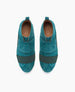 Teal suede slip-on shoes feature wide dark green elastic bands across the top, a pull tab at the heel, and a white rubber sole, with a smooth, rounded toe design. 6