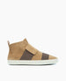 A tan suede high-top sneaker features a wide brown elastic band across the midfoot, a white rubber sole, and a pull tab at the heel. 2