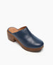 A blue leather clog with a smooth texture, featuring a rounded toe, a wooden platform sole, and a chunky heel. 3