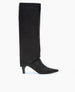 A sleek, black knee-high boot with a pointed toe, smooth leather texture, and a mid-height tapered heel. 6