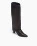 A sleek, black knee-high boot with a pointed toe, smooth leather texture, and a unique folded-over top, featuring a mid-height block heel. 7