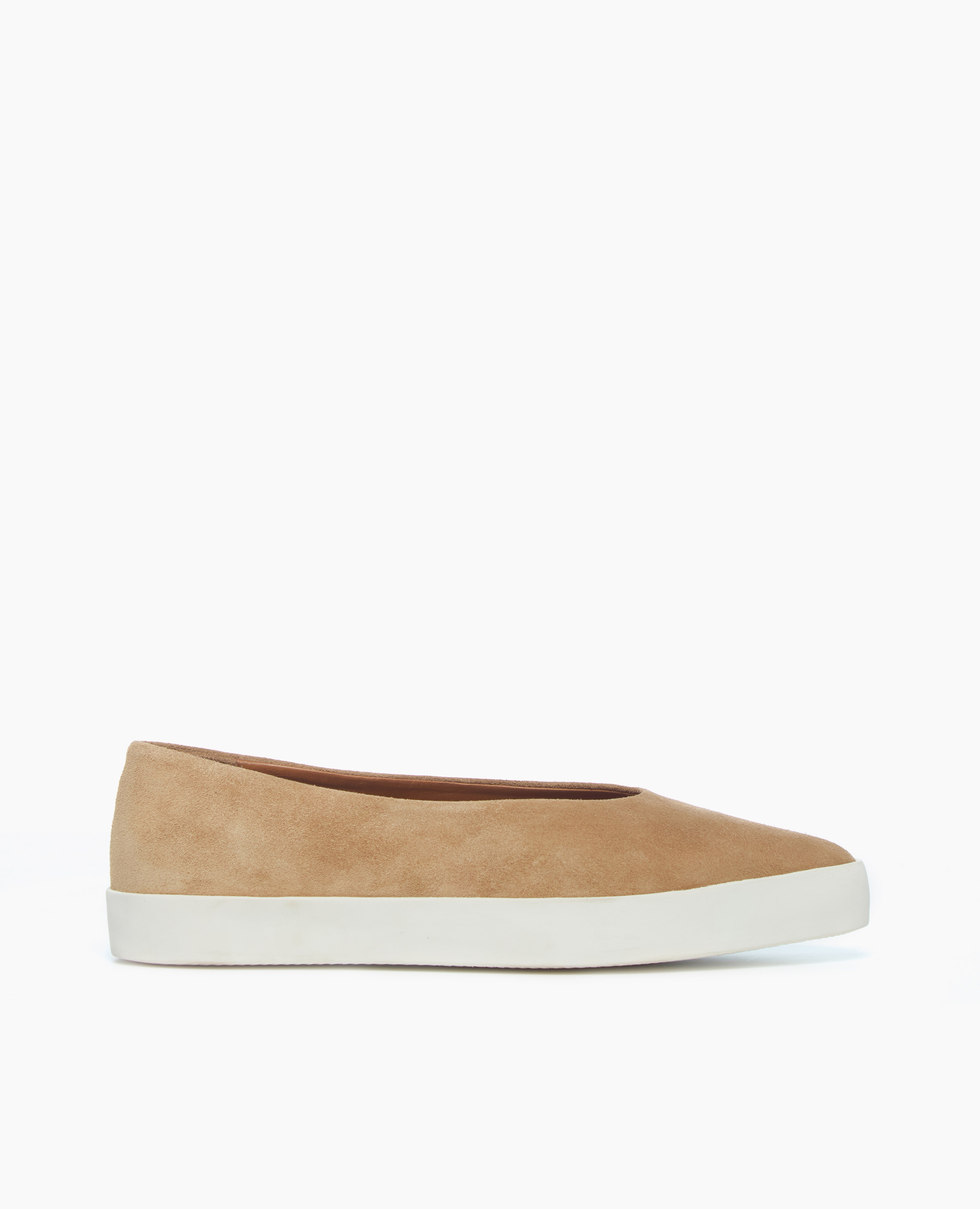 A tan suede slip-on shoe with a smooth texture, a rounded toe, and a white rubber sole.