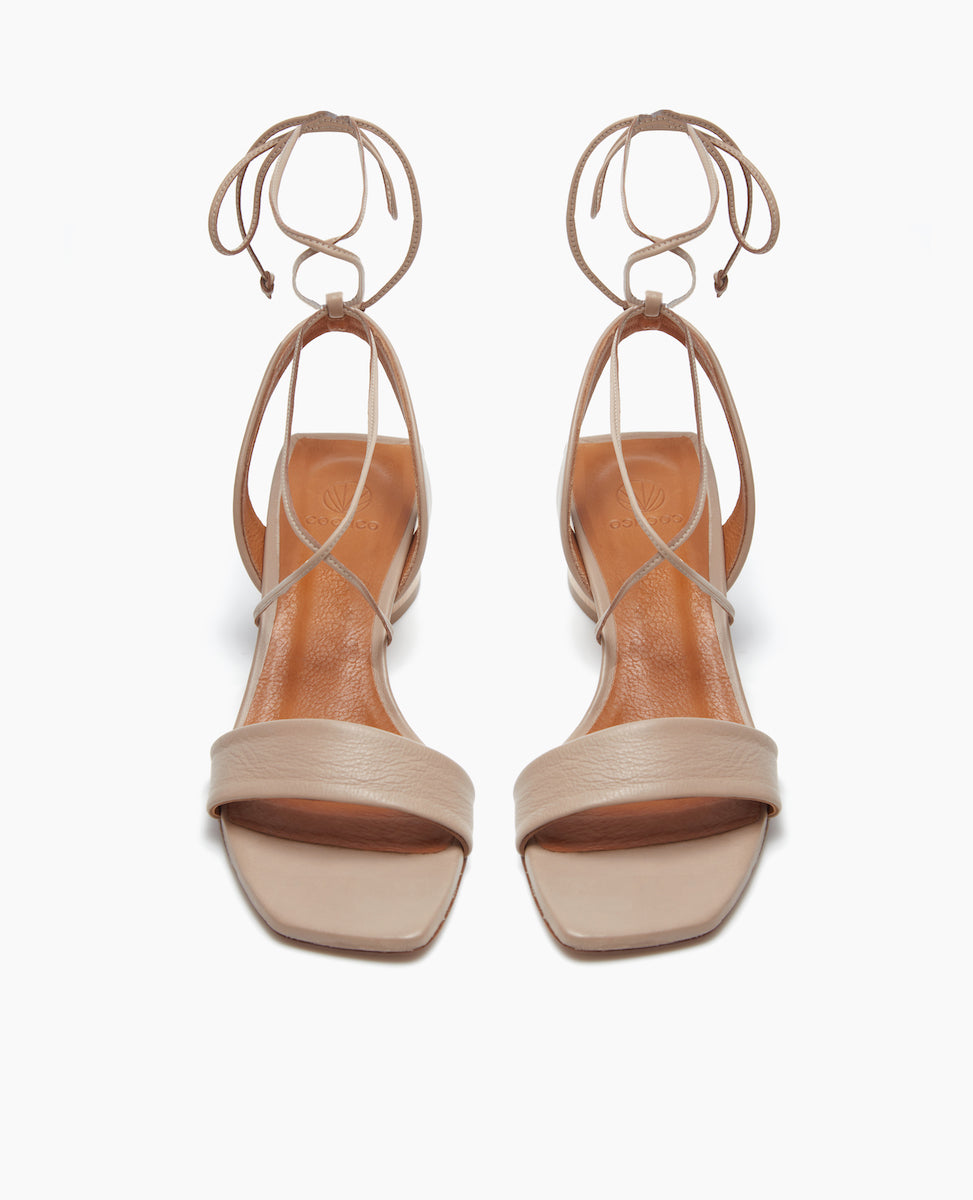 Front view of the Steph Heel in Grey Mist featuring a comfortable leather front band and a winding of leather straps that cascade up the ankle with a tie closure.