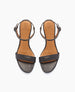 Black leather sandals with a tan insole, featuring a single front strap, an adjustable ankle strap with a buckle, and a flat sole. 4