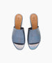 Blue open-toe slides with a smooth, shiny leather upper, tan leather insole featuring a logo, and a simple, sleek design. 4