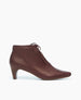 Side view of the Waffles Bootie in Merlot Leather; featuring a softly arched solid wood heel and gathered tie at the ankle revealing just enough to be both feminine and practical. 1