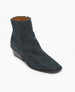 A sleek, dark green ankle boot with a pointed toe, low wedge heel, smooth suede texture, and a side zipper for closure. 5