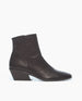 A sleek, black ankle boot with a low, angled block heel and a minimalist design. 1