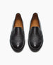 A pair of black leather slip-on shoes with a textured finish, rounded toes, and tan-colored insoles. 3