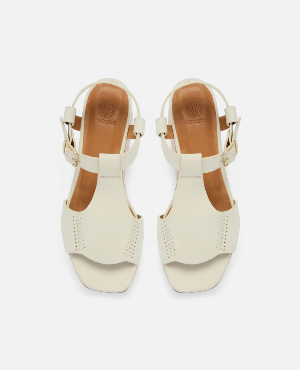 Top view of a white nubuck leather wedge sandal with wide stitched straps, adjustable ankle buckle, and a whitewashed cork platform sole
