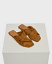 Brown suede sandals with a flat sole, featuring a crisscross strap design and a square open toe. 1