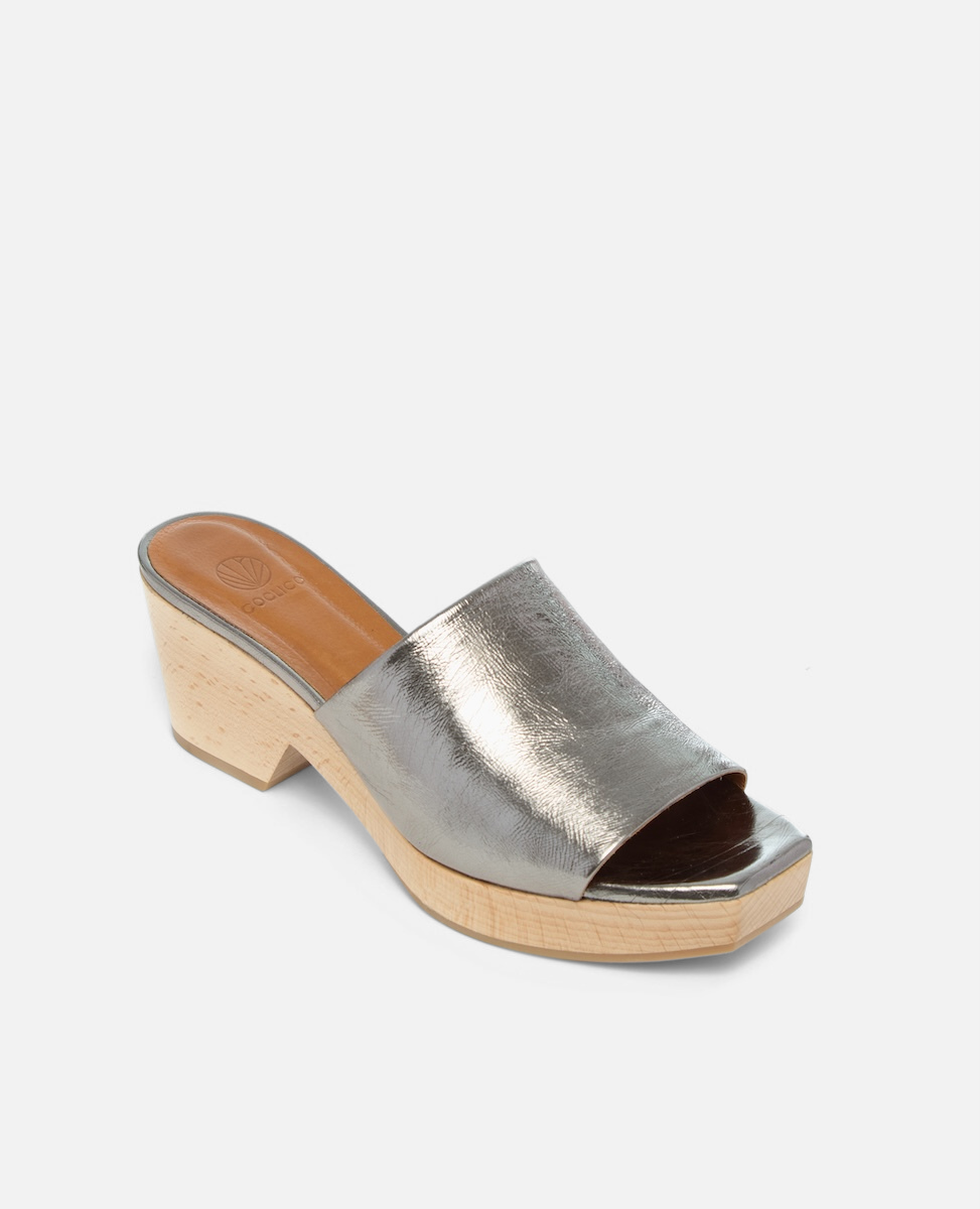 A metallic silver open-toe mule with a smooth leather upper, a wooden block heel, and a tan insole.