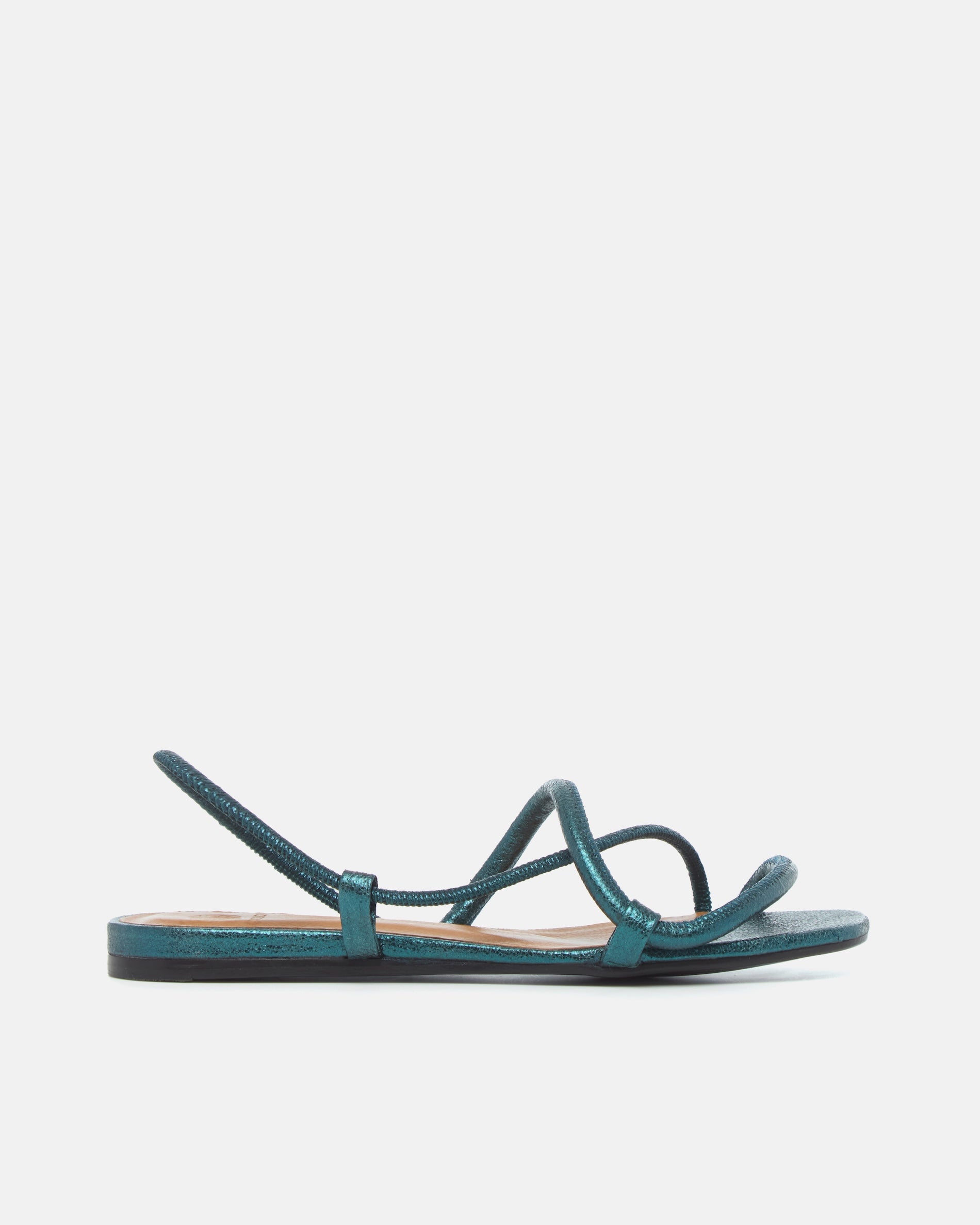 Side view of a metallic blue crinkled leather flat sandal with slim padded straps, elasticated slingback, and a square toe on a grey background