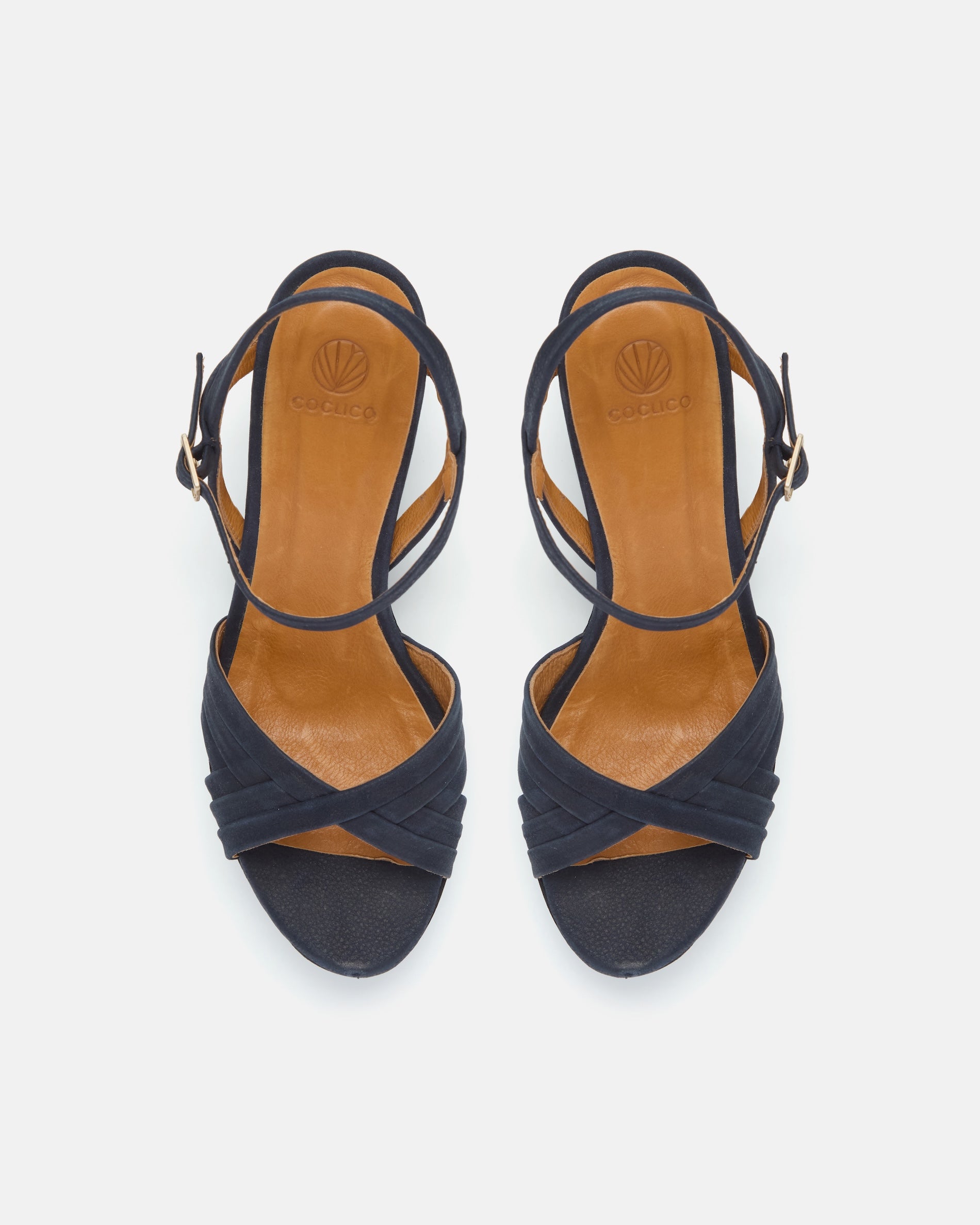 Top view of a navy nubuck leather cork platform sandal with crisscross straps, adjustable ankle strap, and a lightweight cork sole.