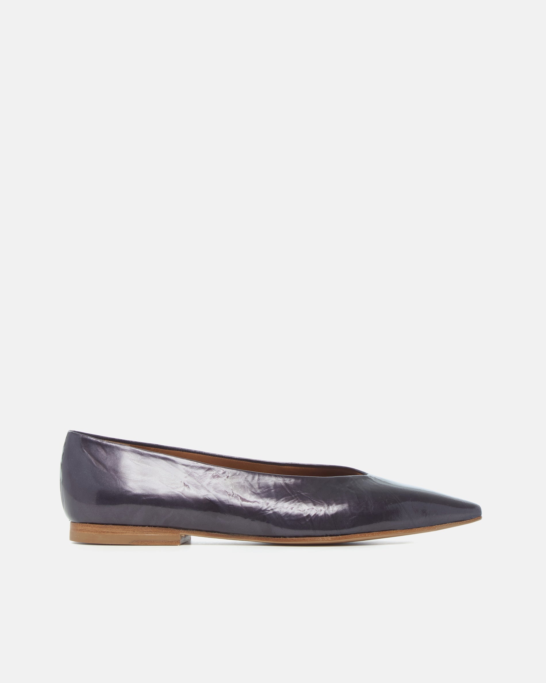 Side view of a black pearl antiqued patent leather pointed-toe flat with clean lines and a flexible leather sole, on a white background.