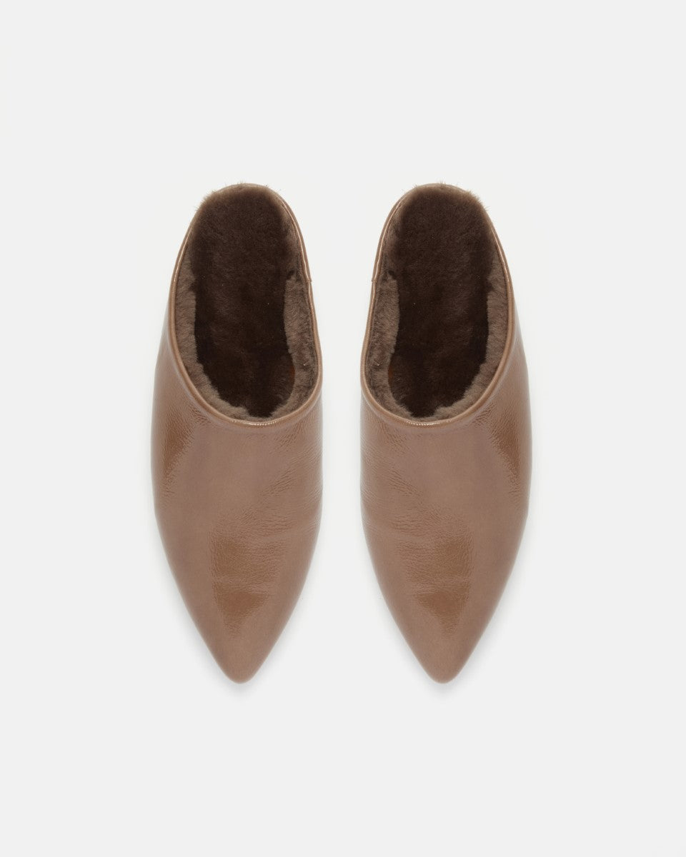 Pair of Coclico Dia Shearling Slides in Boue crinkled patent, top view with shearling lining