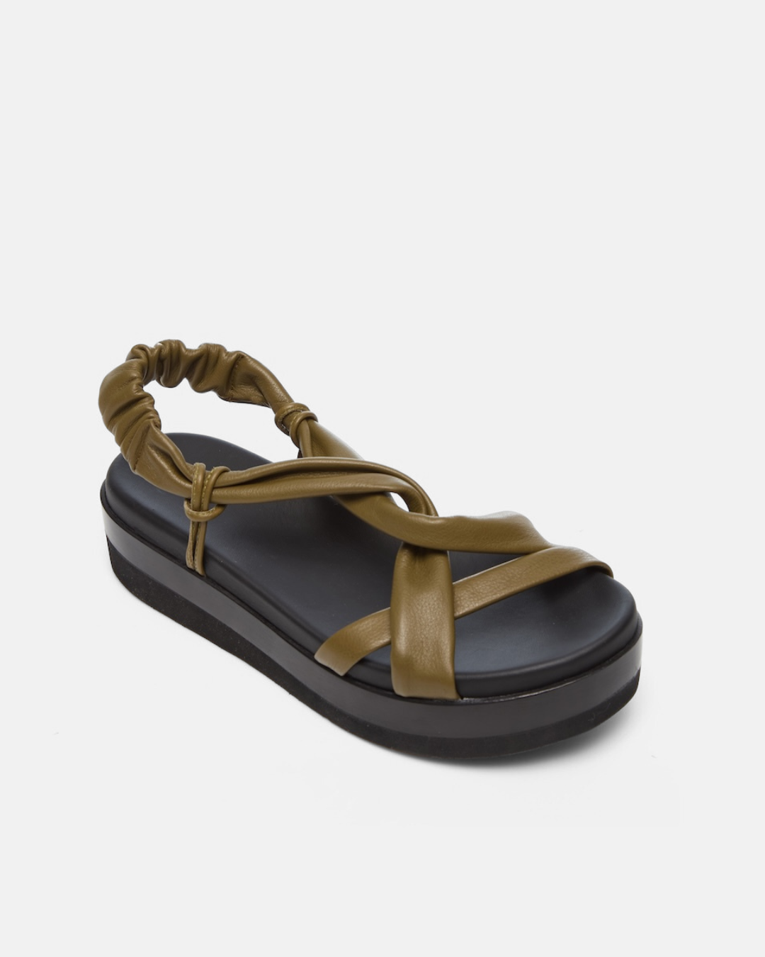 Angled view of a sandal featuring a thick black platform sole, olive green leather straps with a crisscross design, and an elasticized back strap for a secure fit.