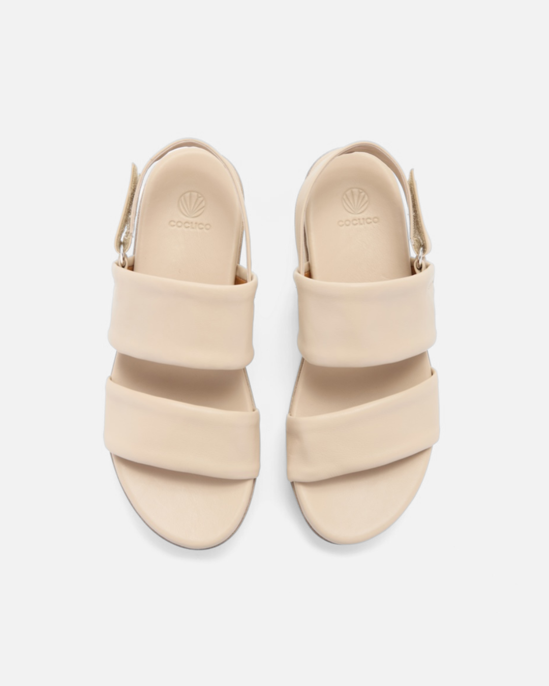 Top view of a off-white leather wedge sandal with wide tubular straps, velcro slingback, and a lightweight EVA platform sole