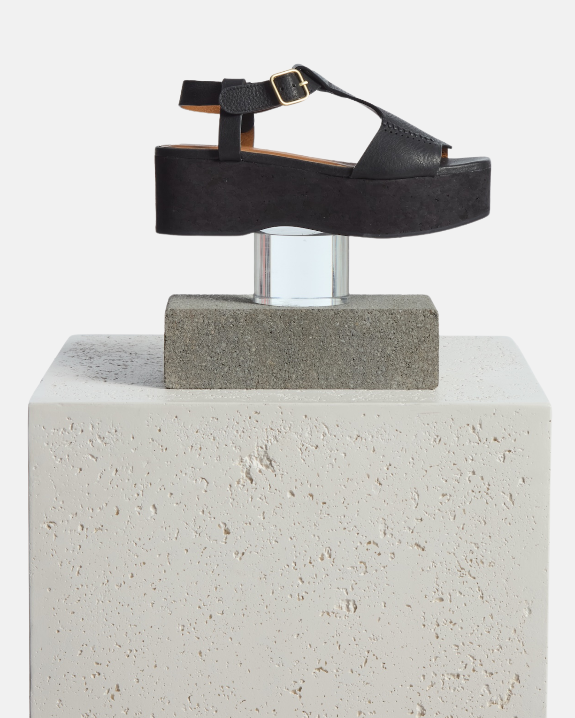 Wedge on a pinth: black leather wedge sandal with wide stitched straps, adjustable ankle buckle, and a black-stained cork platform sole