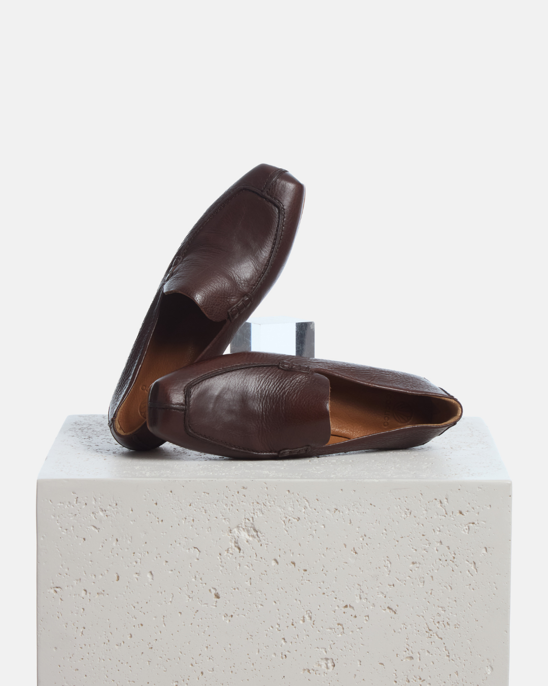 Coclico Francis Loafer in Castagno, soft brown leather loafers styled on a stone plinth