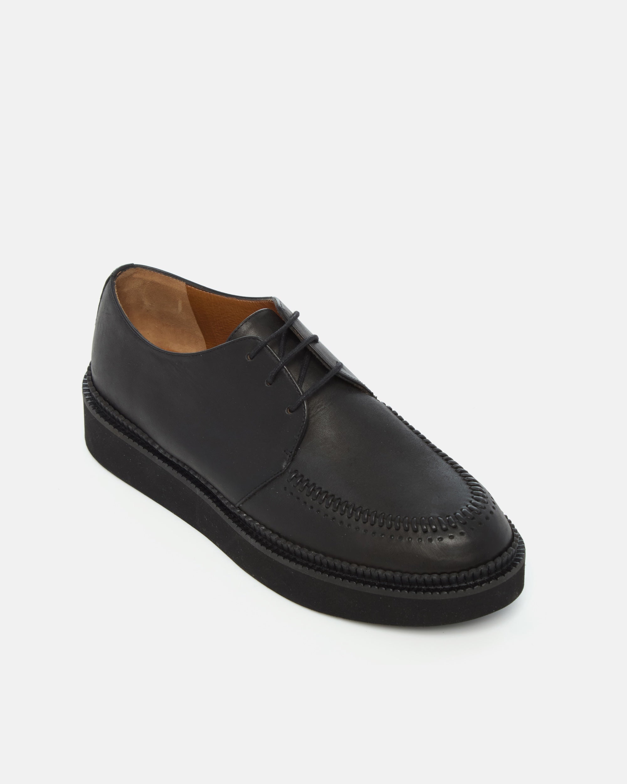 Coclico Gali Creeper in black leather, angled view of the apron moc toe and chunky platform sole