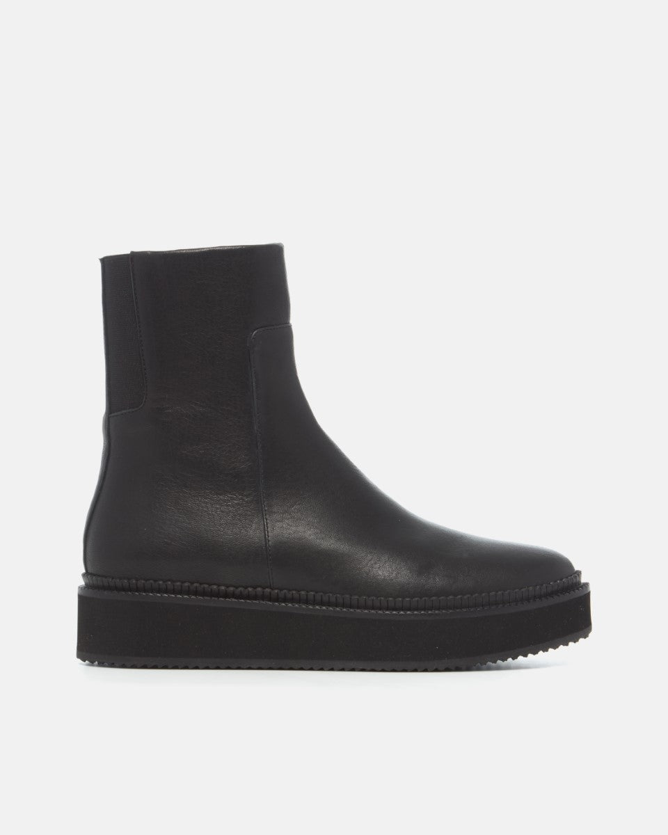 Coclico Greta Boot in black leather, side view of a sleek flat ankle boot with platform sole