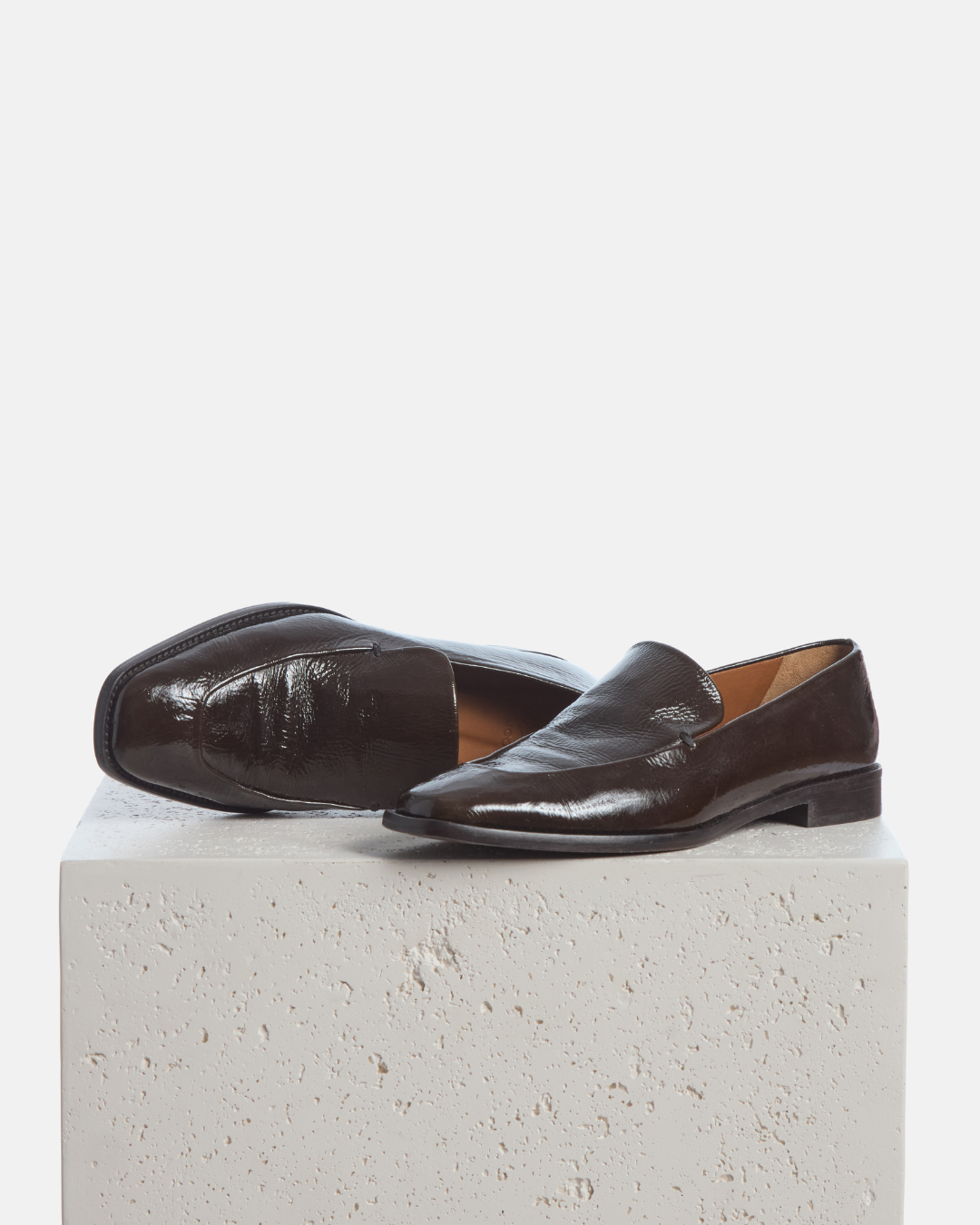 Coclico Halyn Loafer in Moule crinkled patent, square toe loafers styled on a stone plinth