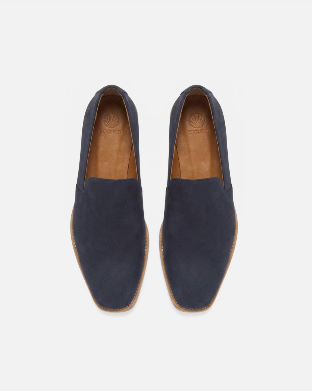 Top view of a navy nubuck leather slip-on loafer with a tapered square toe and low stacked heel on a white background