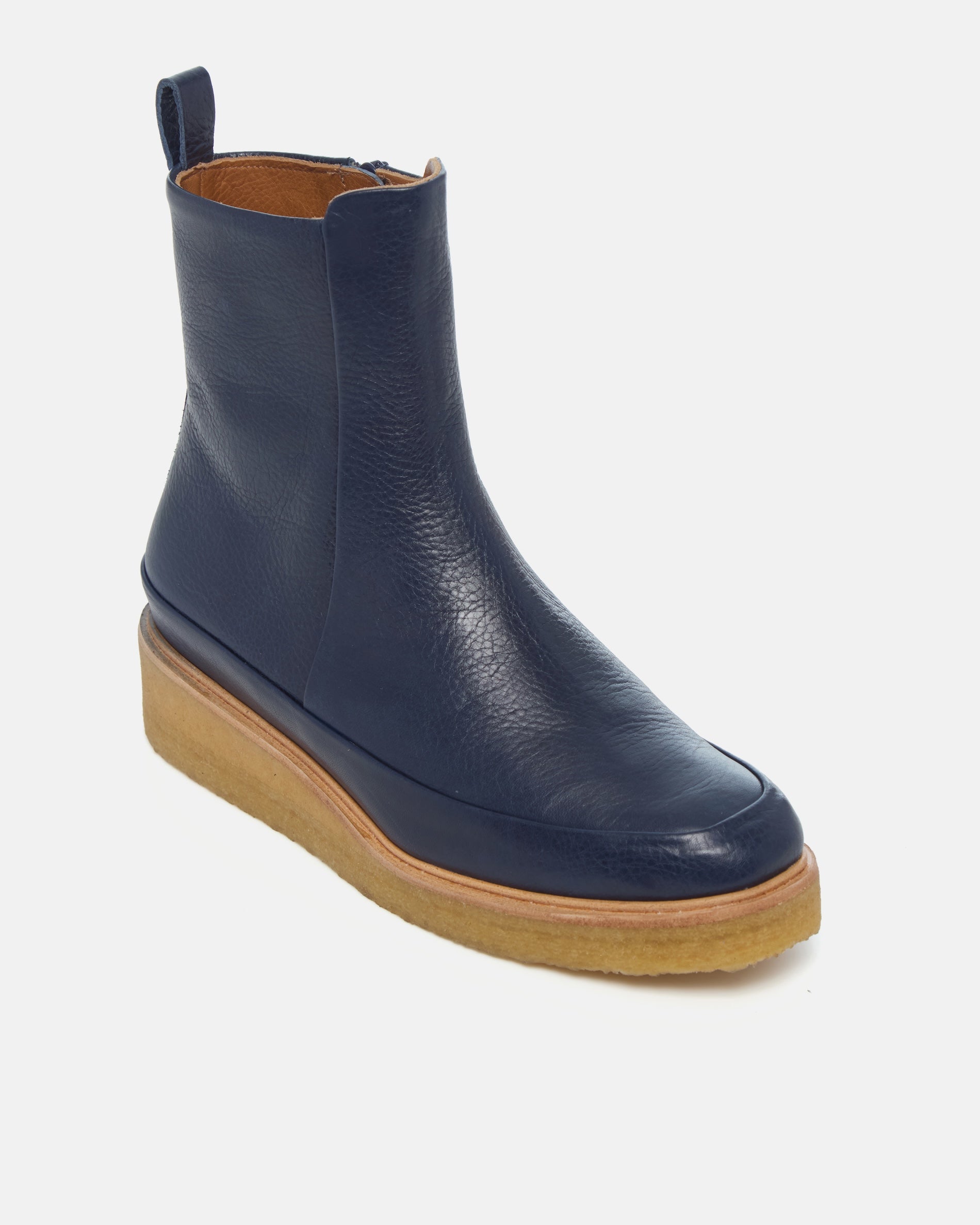 Coclico Hip Boot in Marino navy leather, angled view of the crepe sole