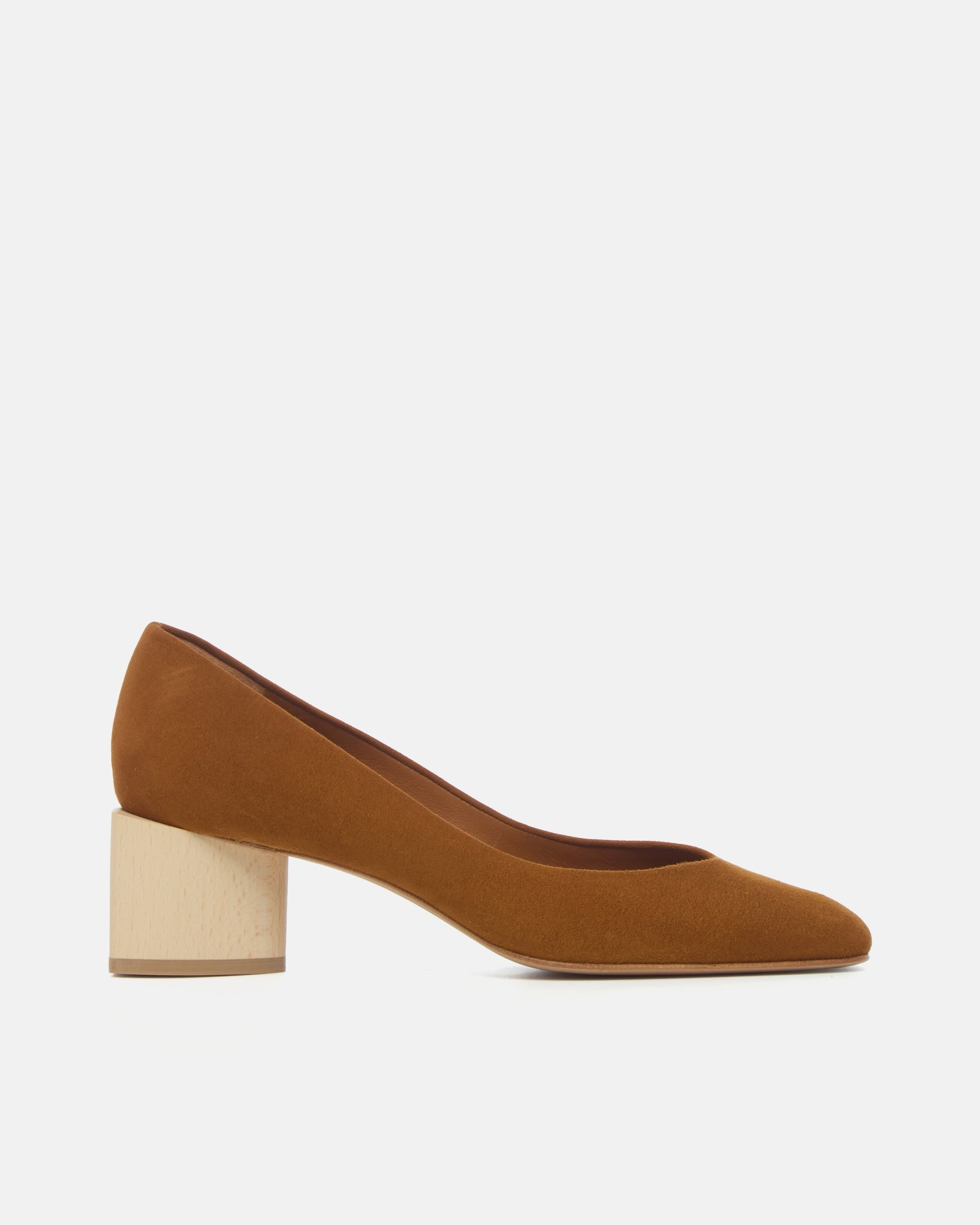 Side view of a brown suede pump with a square toe and a solid architectural wood block heel on a white background