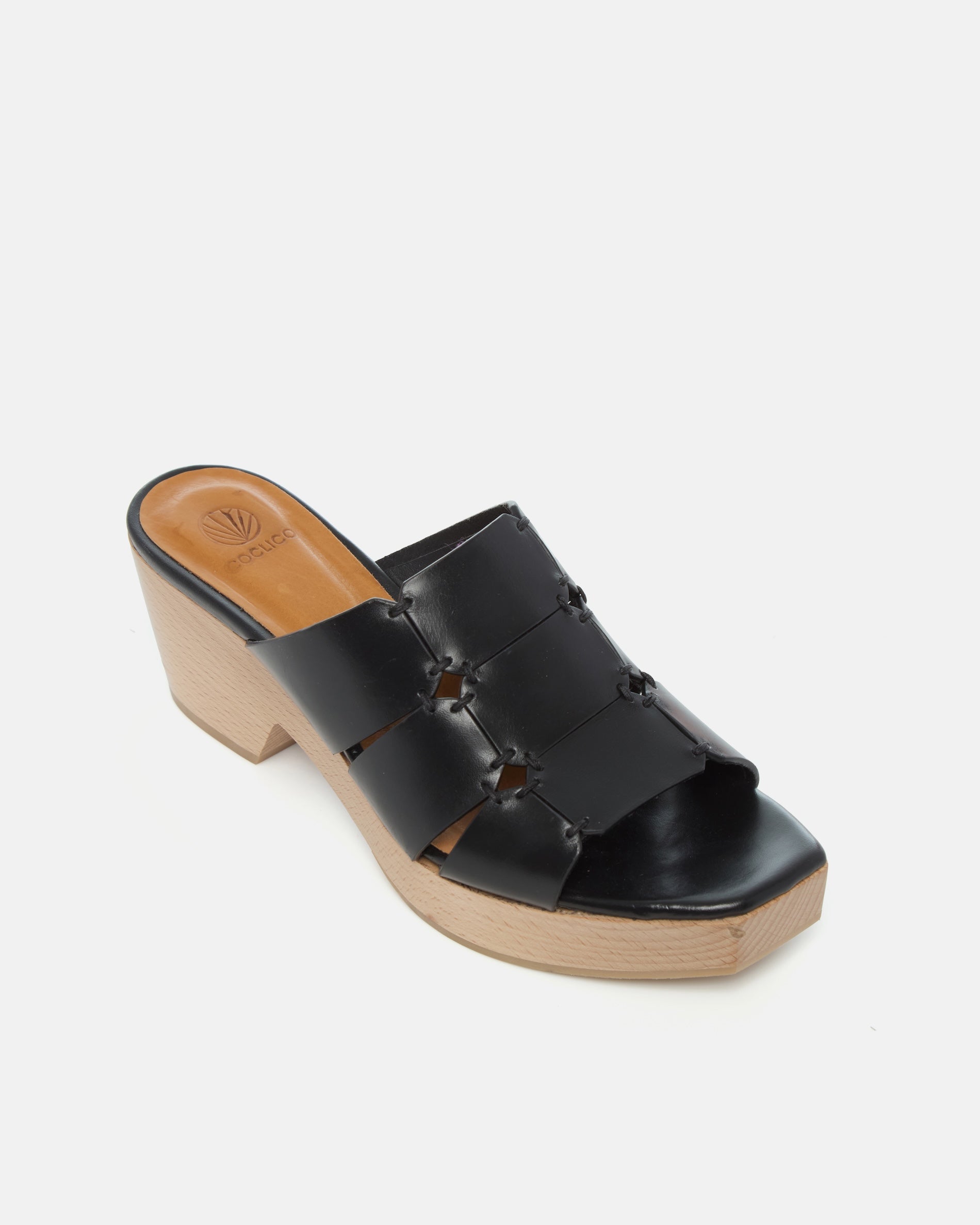 Angled view of a clog sandal in black leather featuring linked straps, wooden heel, and open toe slip-on design