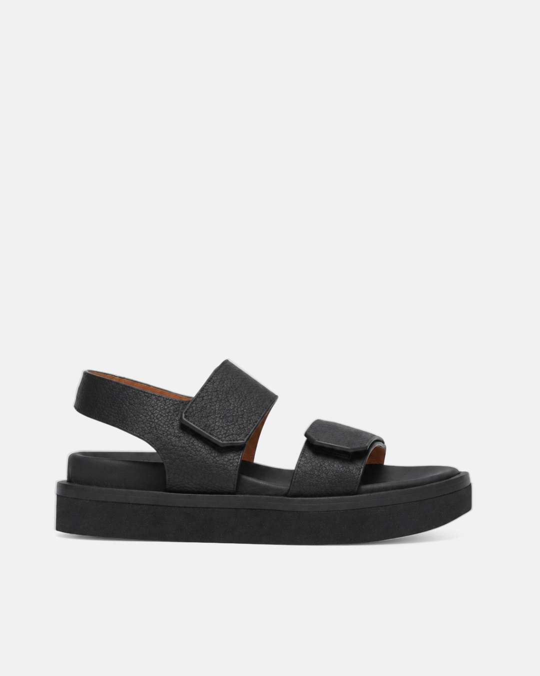 Side view of a black wedge foot bed sandal with a wide front strap and wide quarter strap fastened by velcro