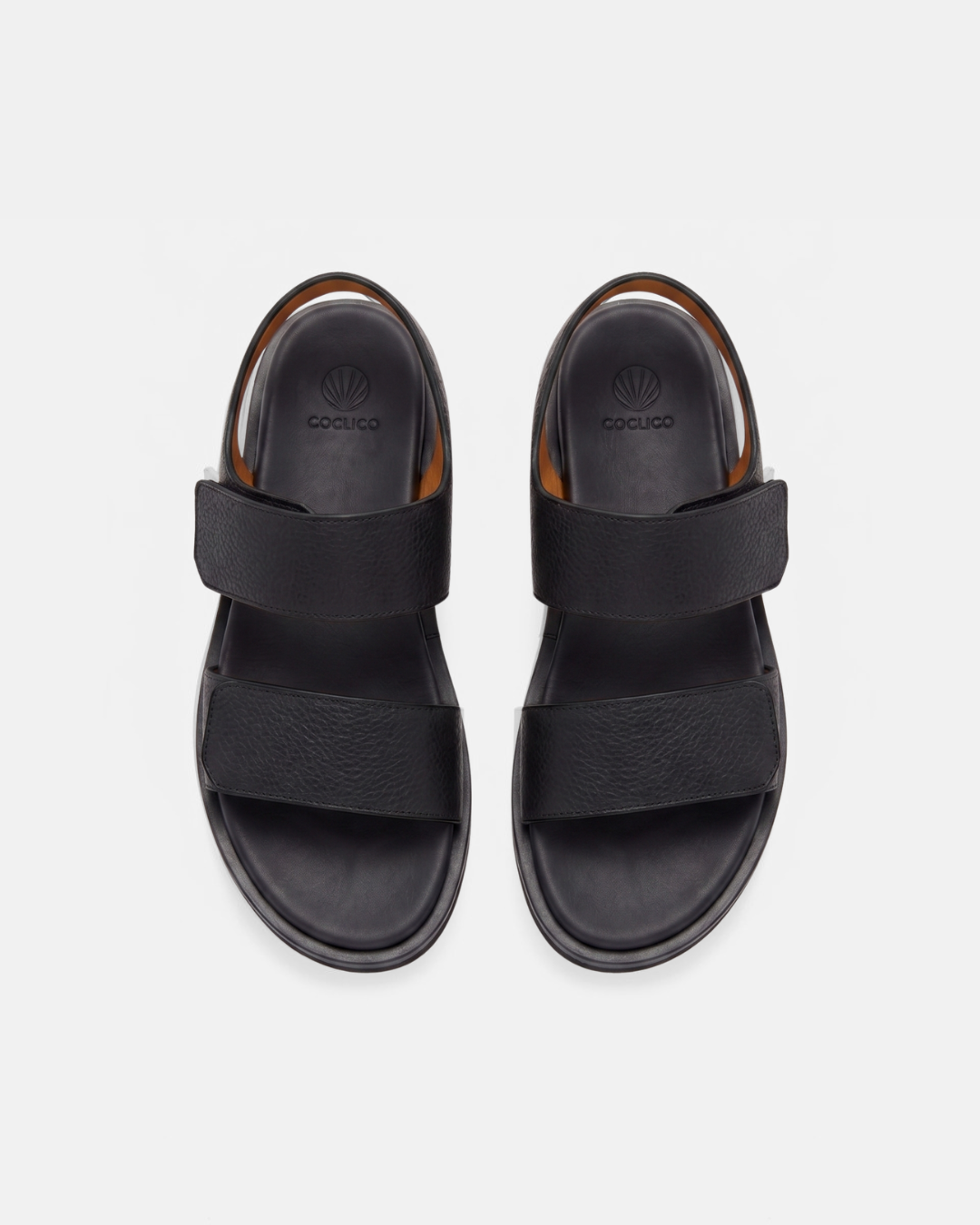 Top view of a black wedge foot bed sandal with a wide front strap and wide quarter strap fastened by velcro