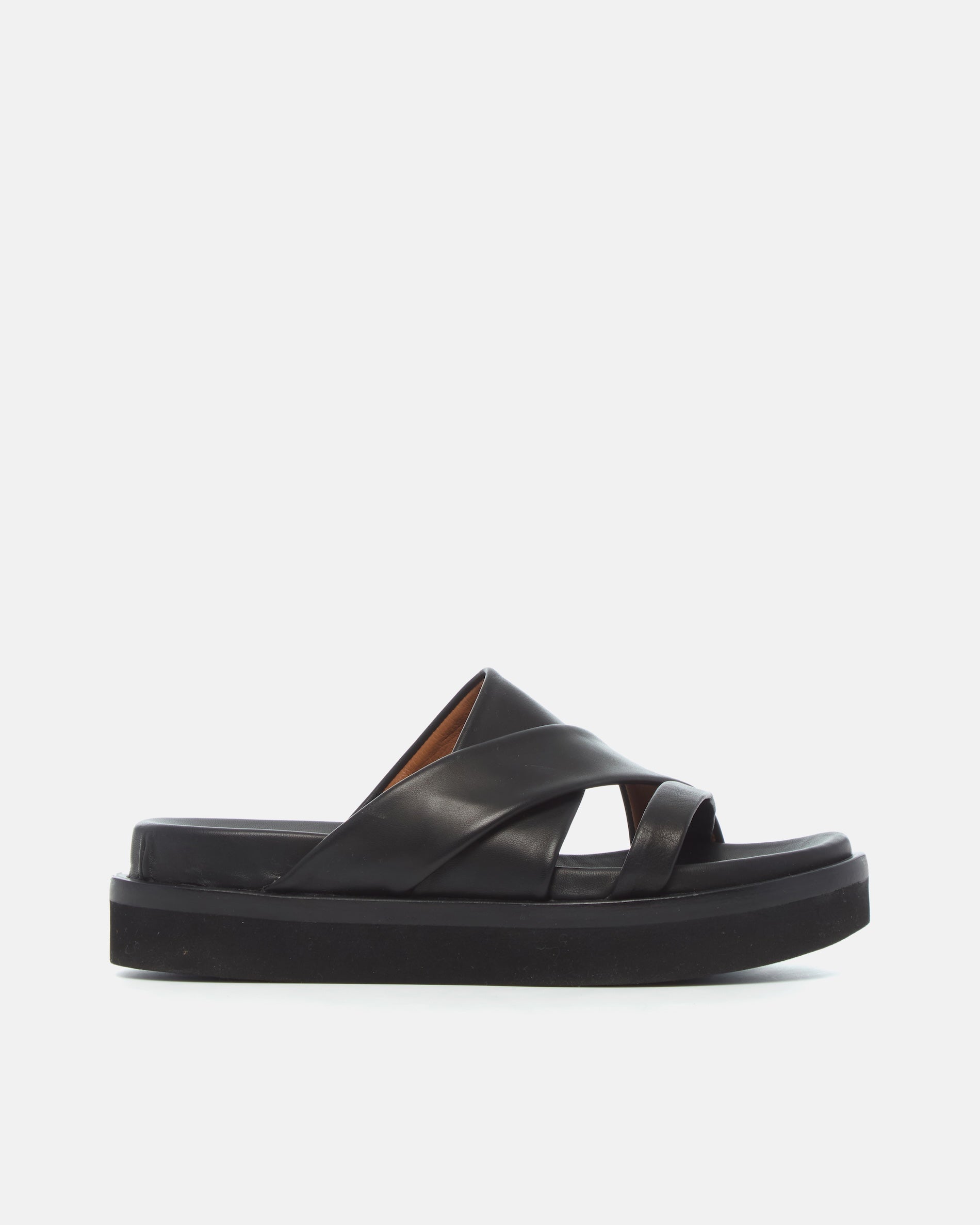 Side view of a black leather footbed sandal with wide folded straps and a sleek cushioned platform sole