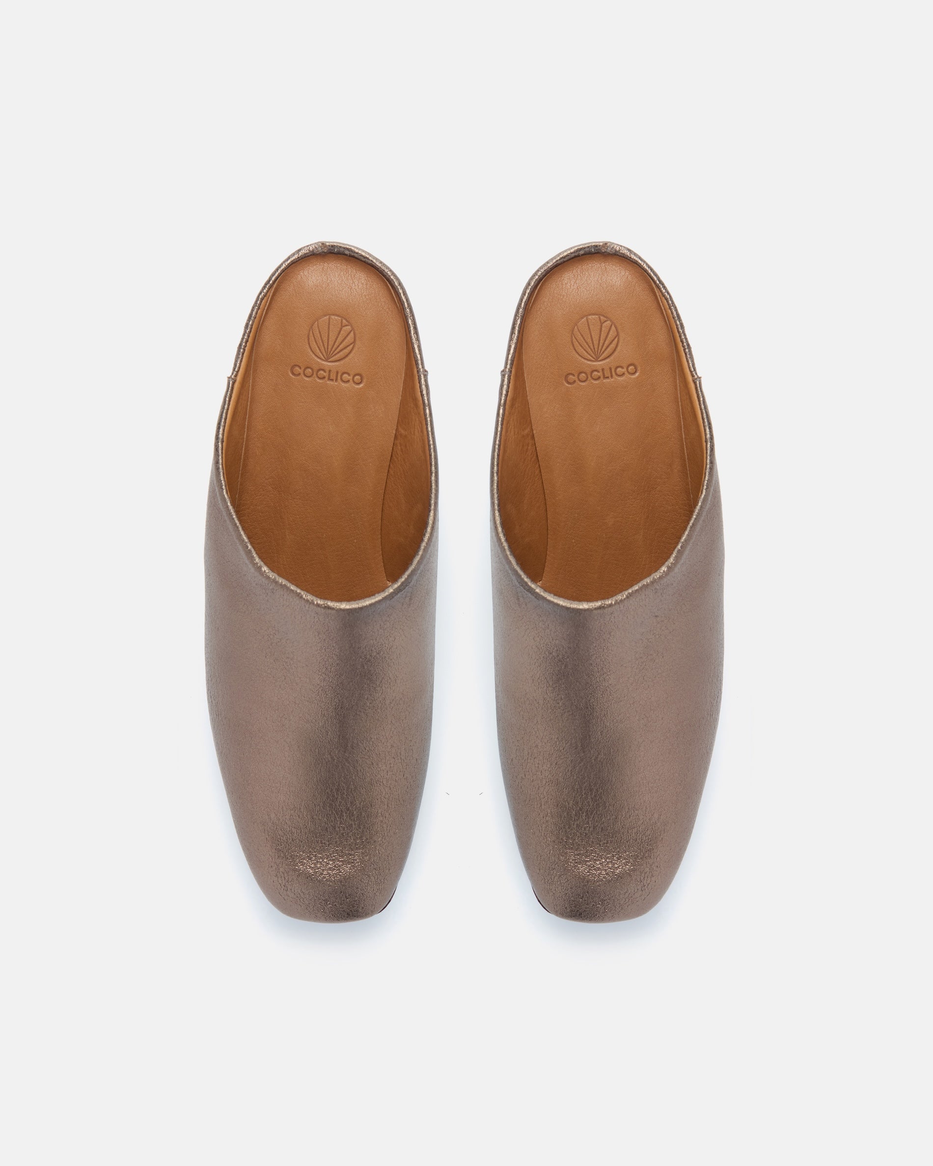 Pair of Coclico Quilla Clogs in Bronze crinkled metallic, top view of closed toe clog mules