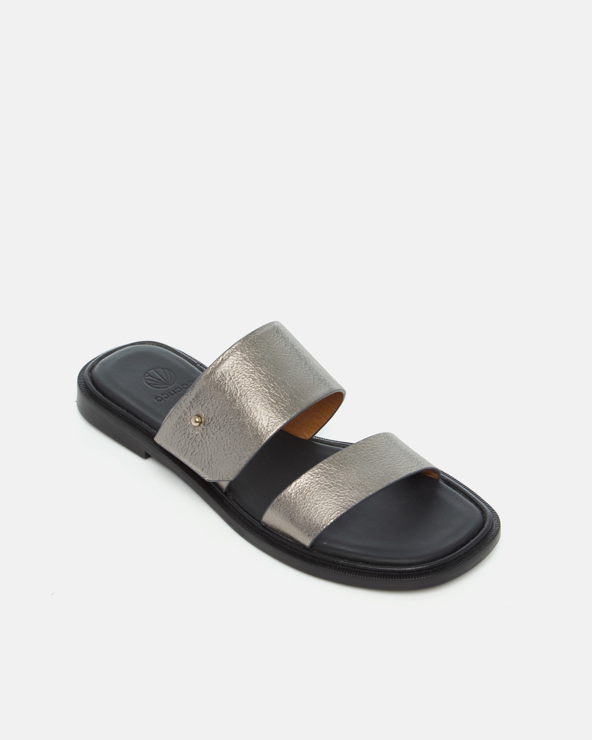 Angled view of a pewter metallic leather slide sandal with two wide straps, a subtle metal peg detail, cushioned leather footbed, and flat leather sole