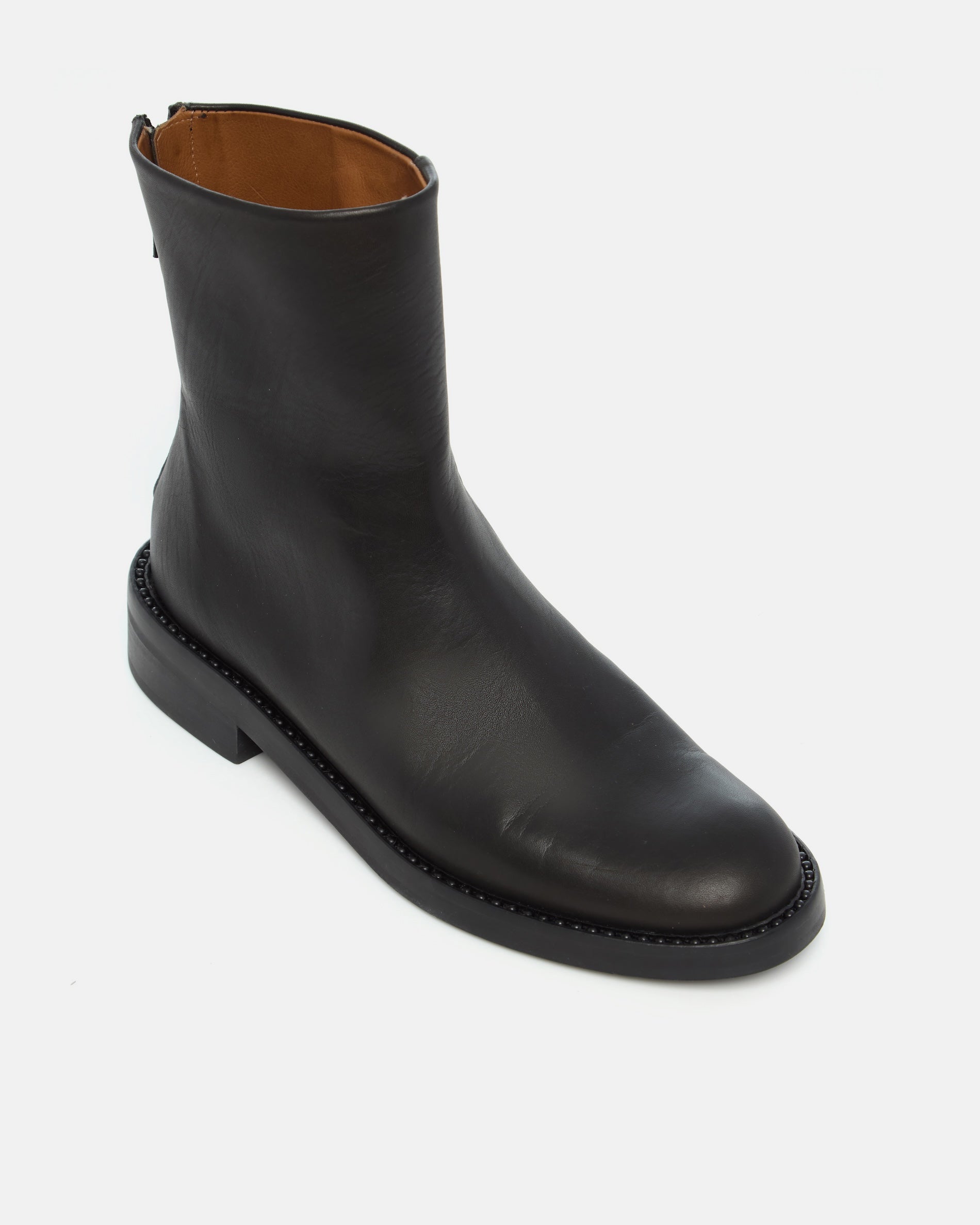 Coclico Tama Boot in black leather, angled view of the round toe and stacked sole