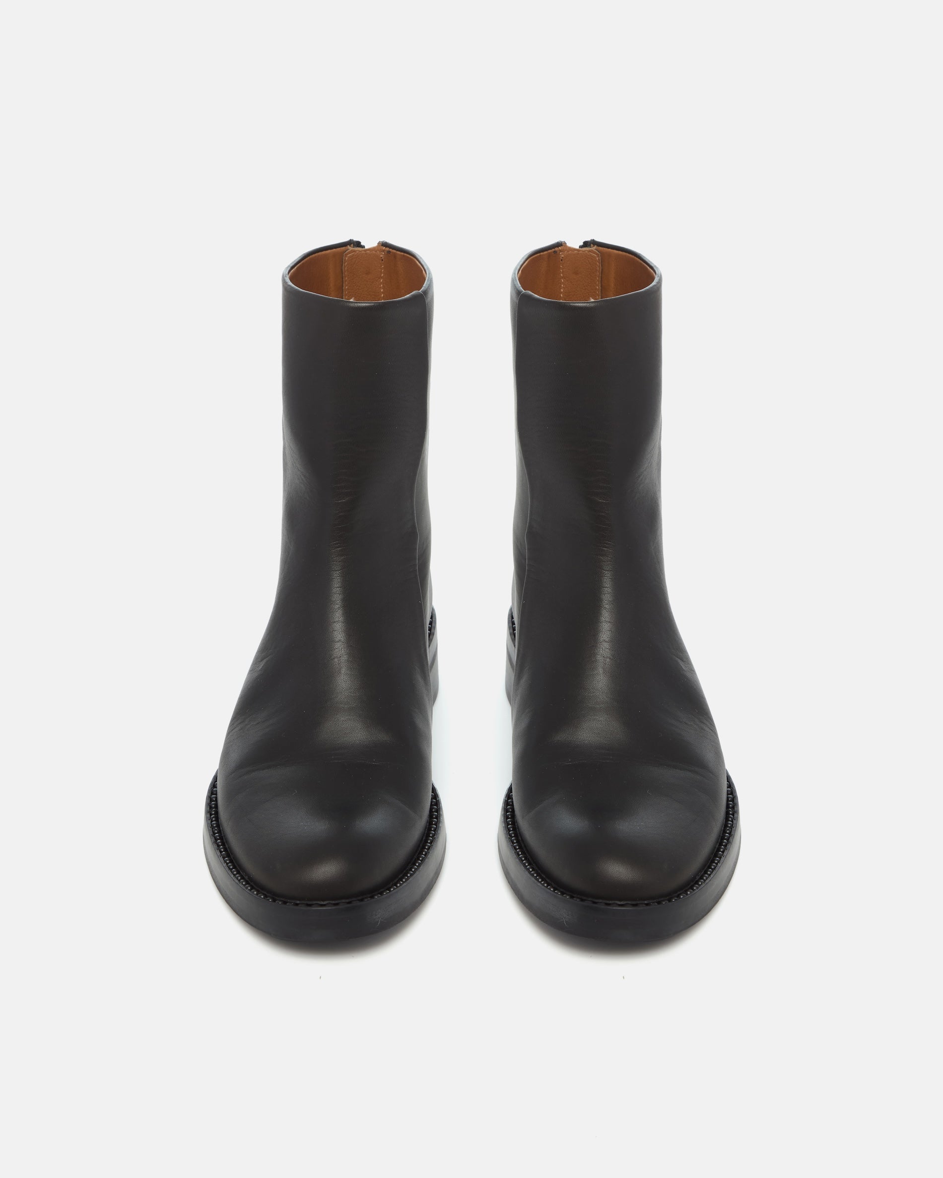 Pair of Coclico Tama Boots in black leather, front view of flat ankle boots
