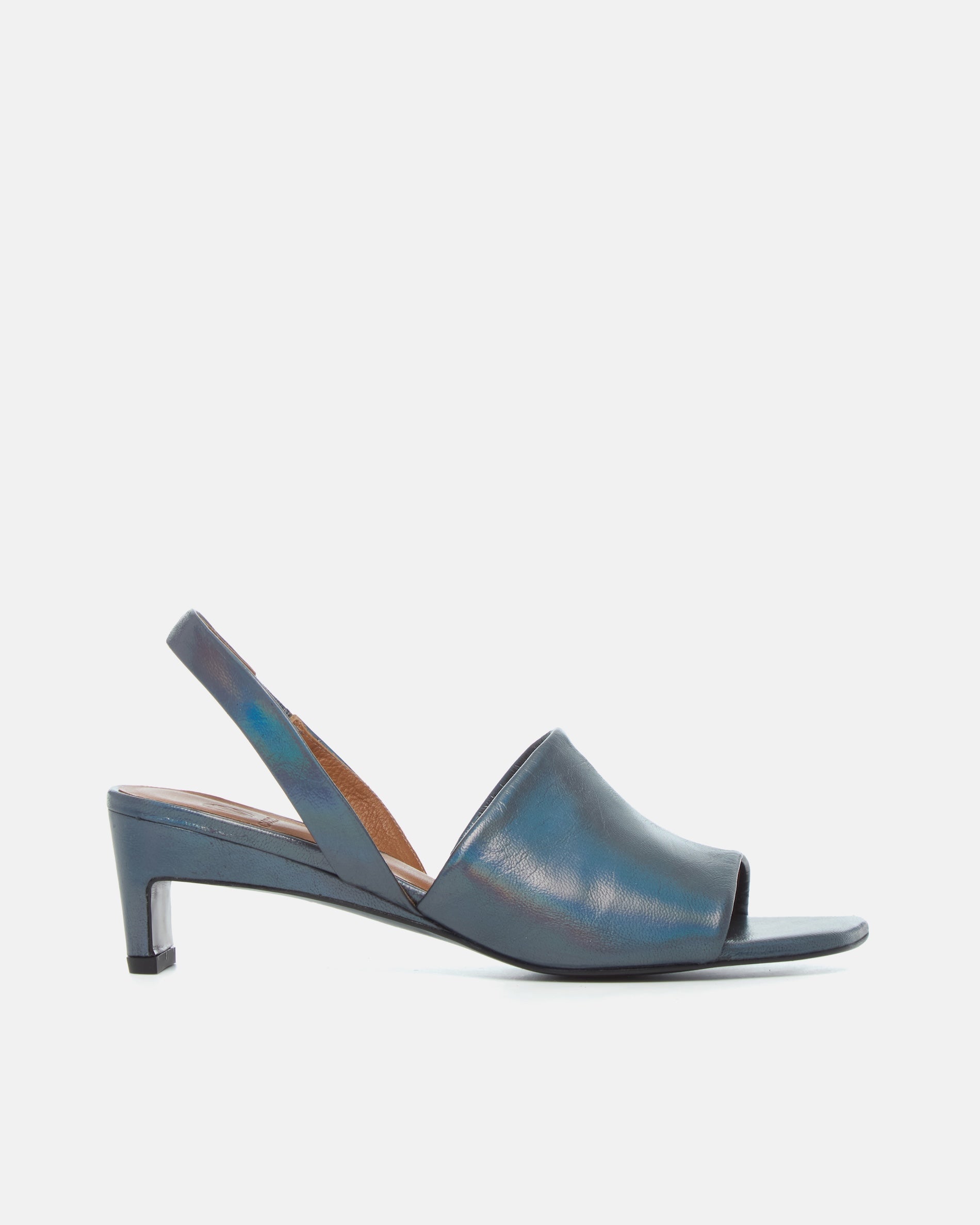 Side view of a iridescent blue leather mid-heel sandal with a wide band, delicate slingback, squared toe, and sculptural block heel