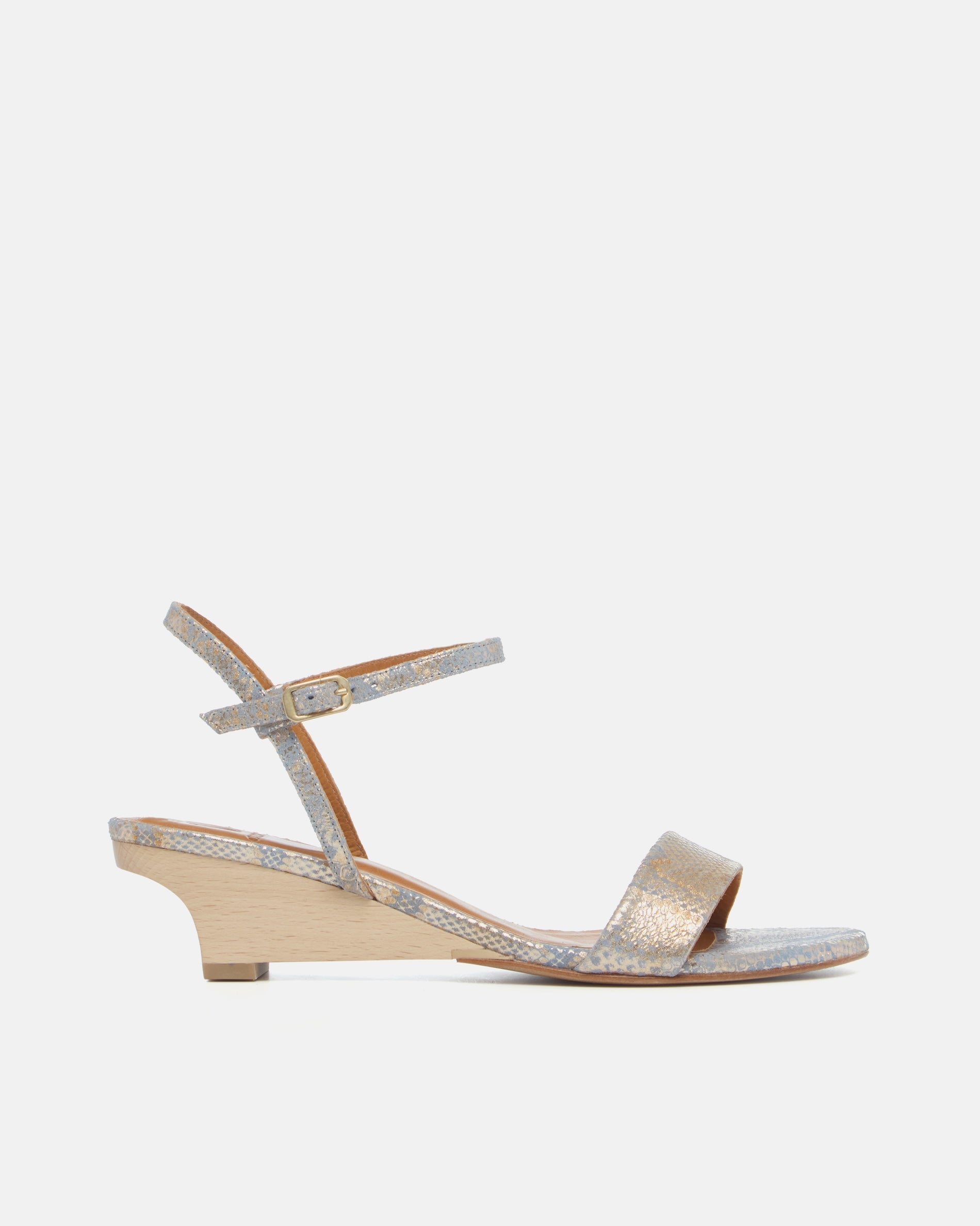 Side view of a gold and blue snake print leather demi-wedge sandal with a slim strap, ankle buckle, and sculptural wooden wedge.