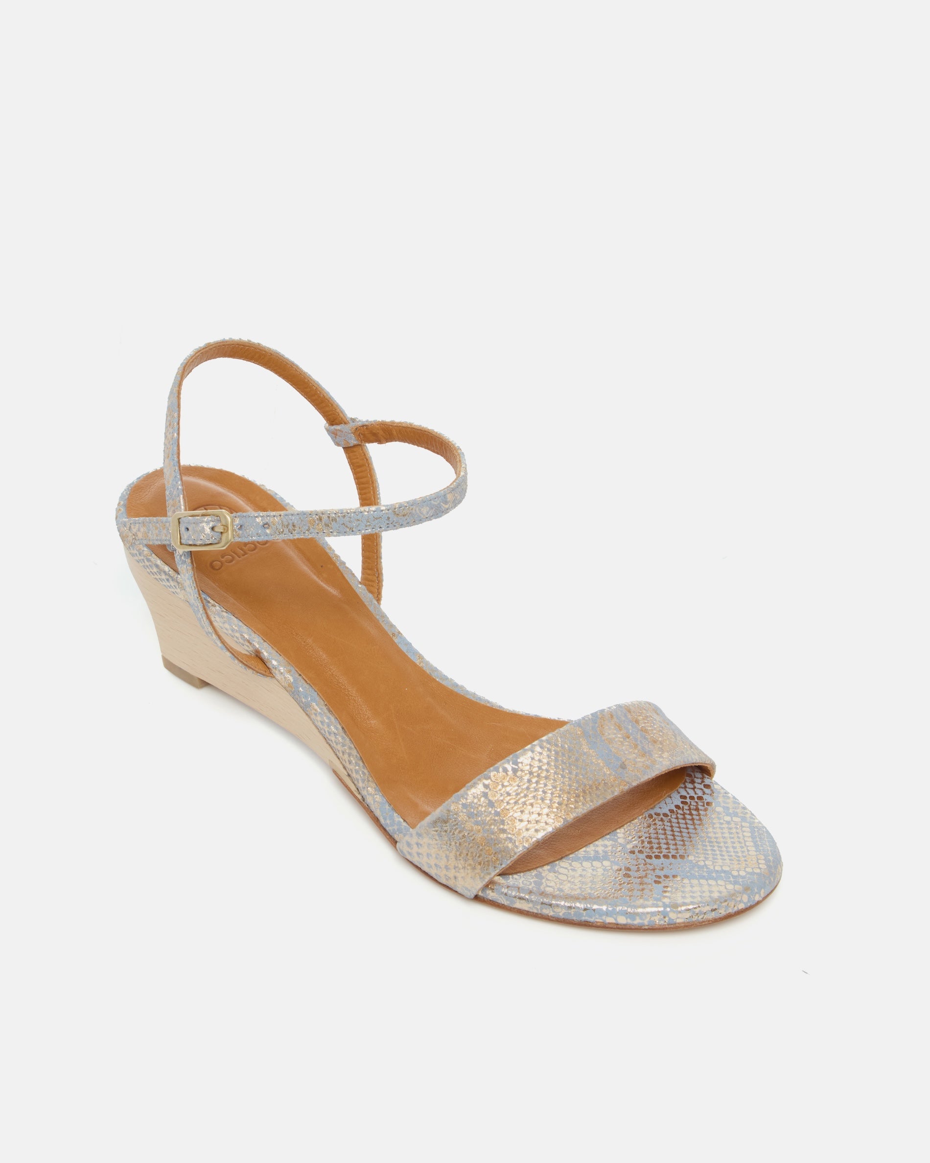 Angled view of a gold and blue snake print leather demi-wedge sandal with a slim strap, ankle buckle, and sculptural wooden wedge.