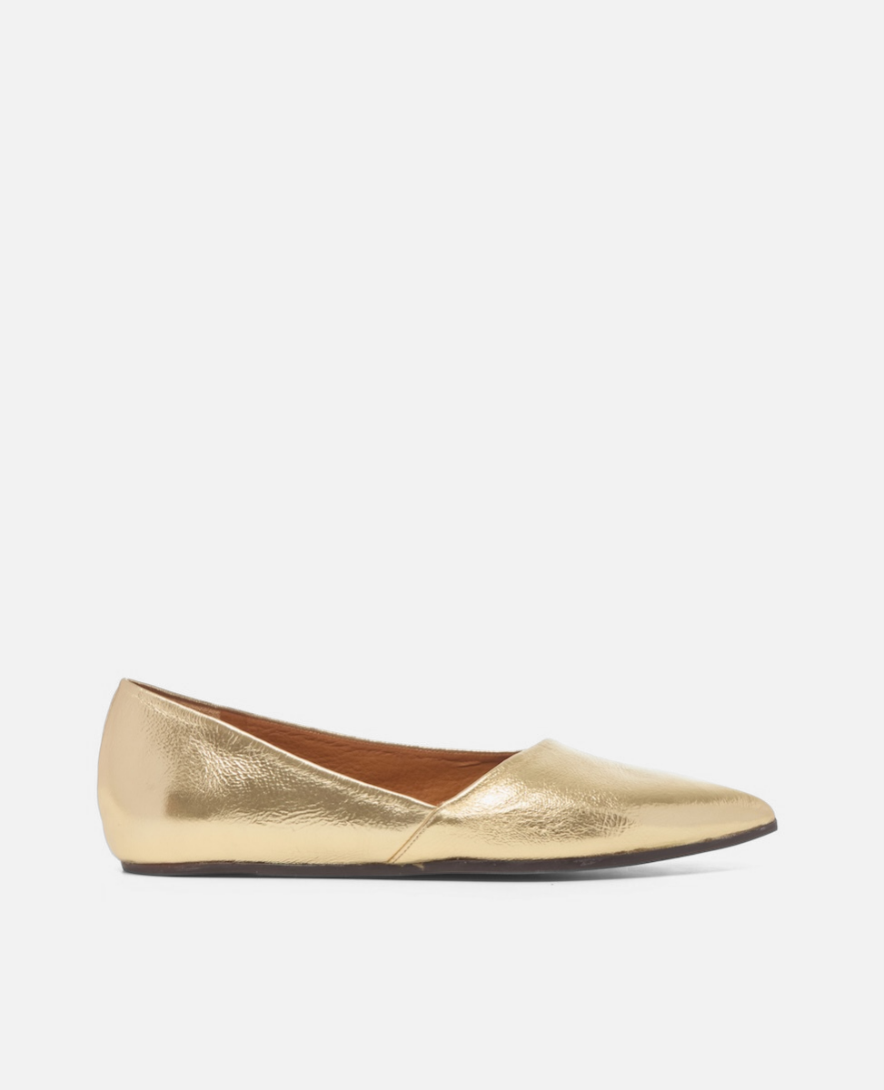 Gold flat shoe on a white background