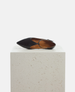 Black flat shoe with a strap on a light gray pedestal against a white background 4