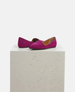 Pair of pink suede shoes on a light gray pedestal against a white background 4