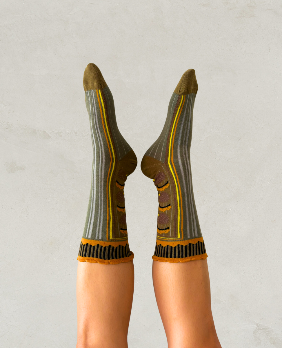 Person wearing patterned socks with a neutral background