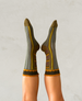 Person wearing patterned socks with a neutral background 1
