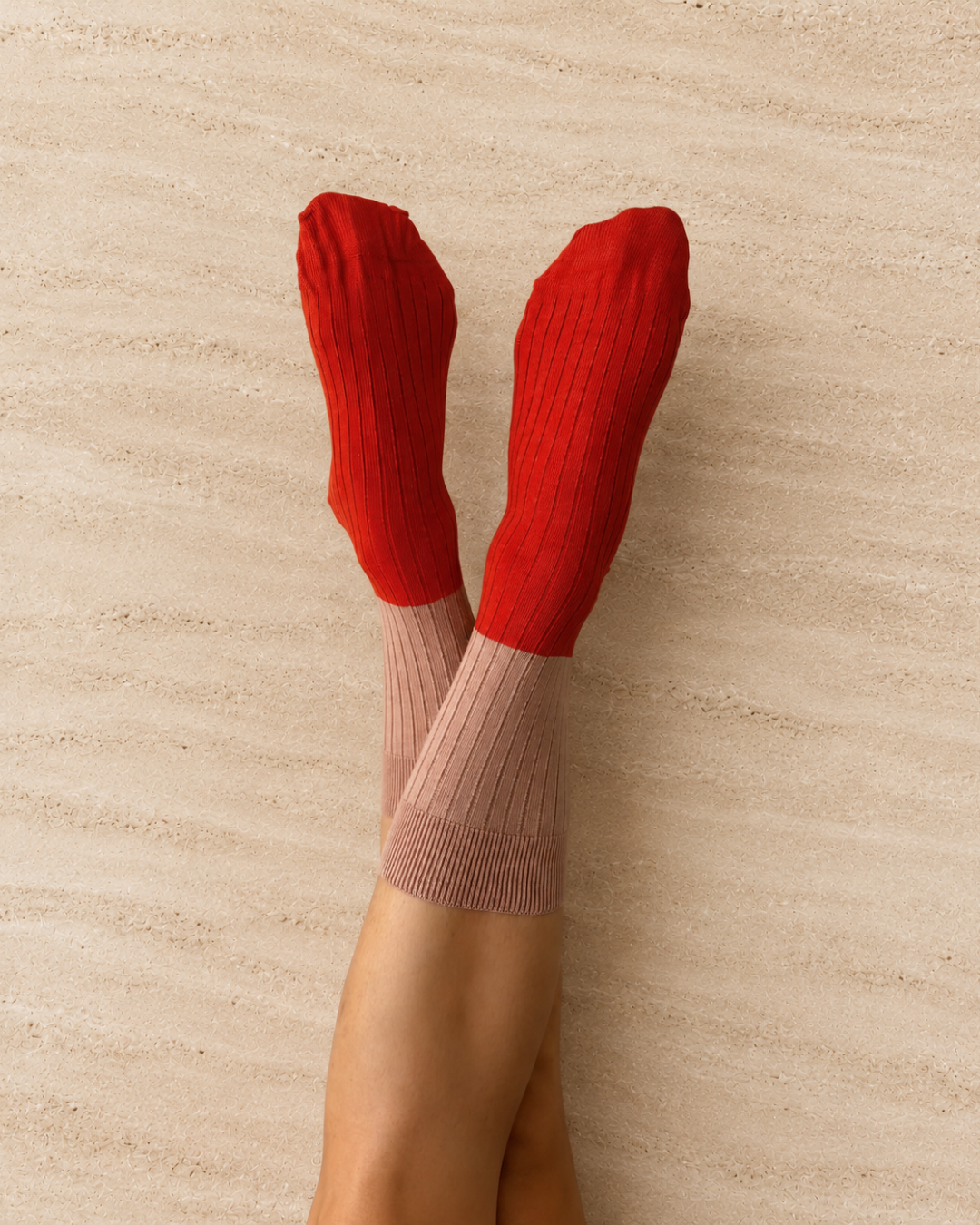 Escuyer Red and beige ribbed knee-high socks worn on a neutral background