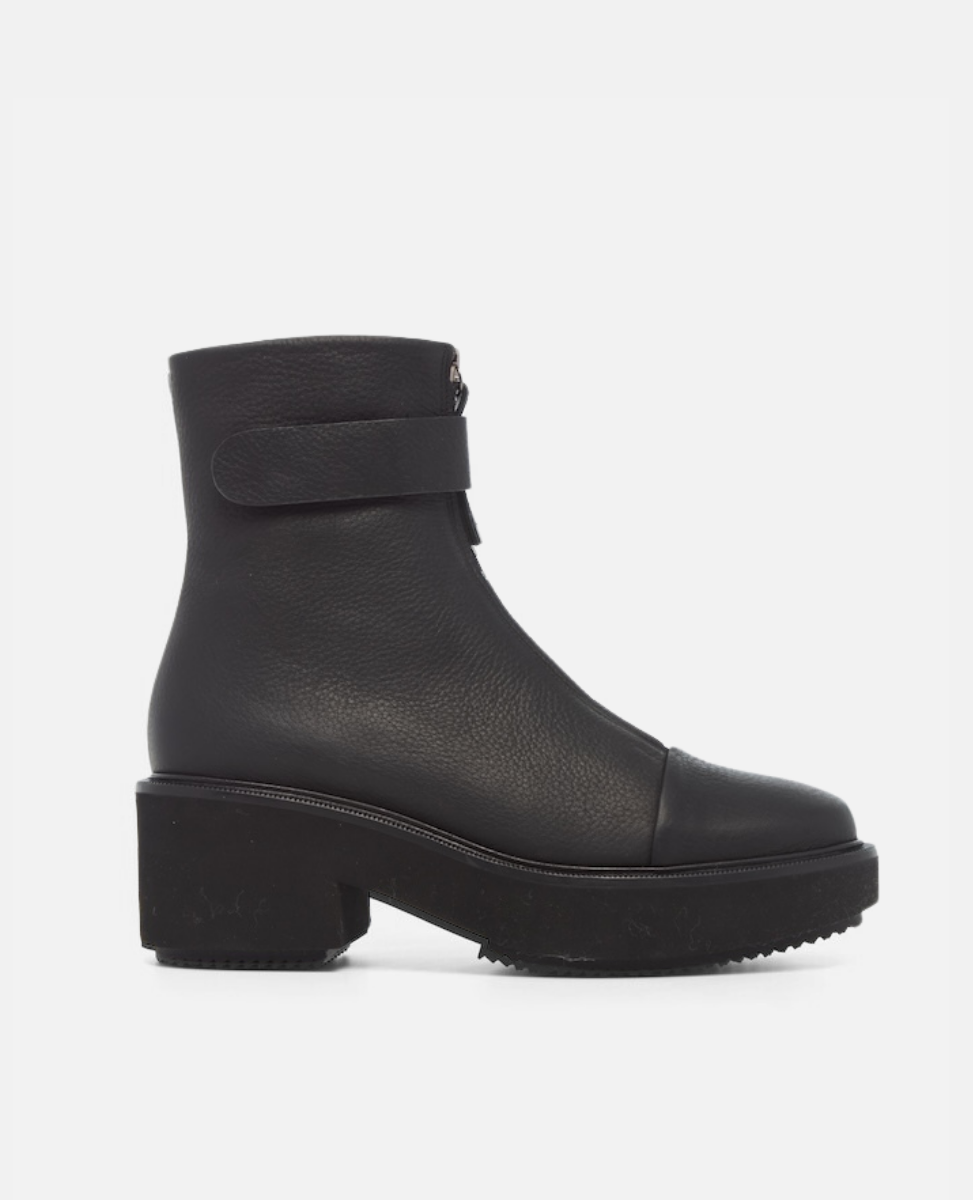 Black ankle boot with a platform sole on a white background